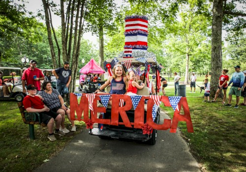 Children celebrate on a decorated golf cart with 